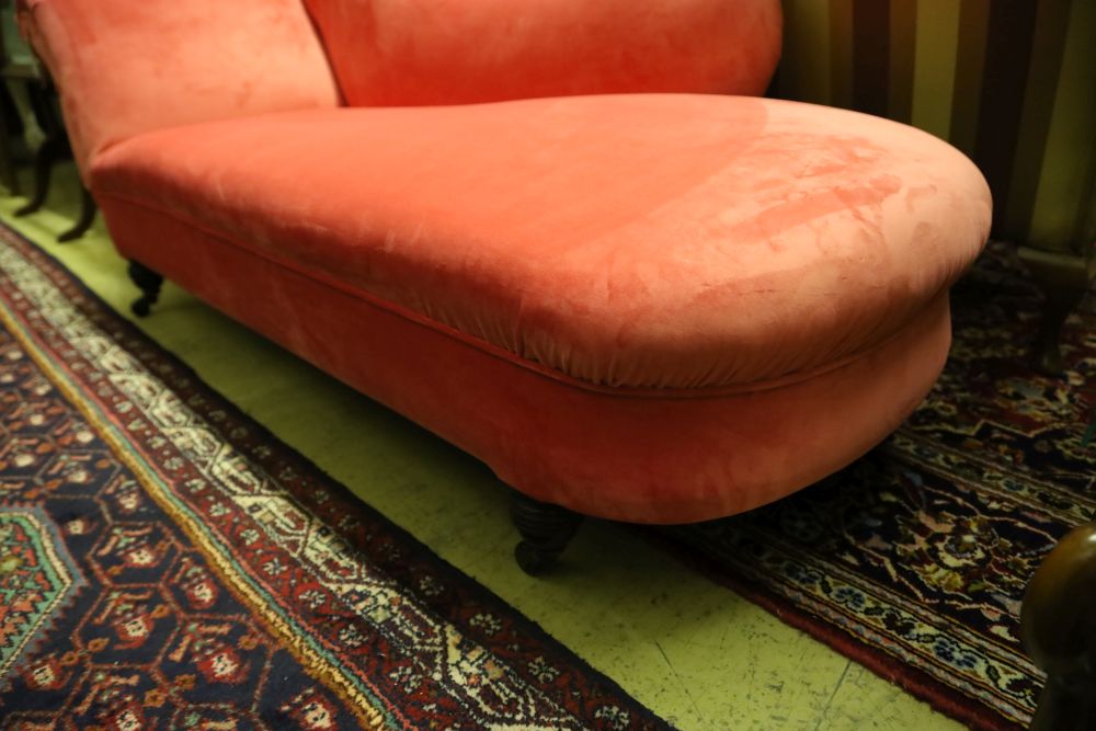 A Victorian chaise longue upholstered in pink velvet, width 180cm, depth 66cm, height 74cm